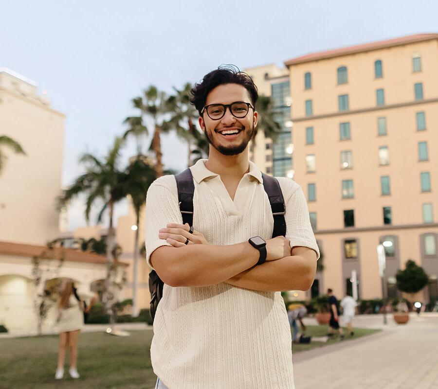 biblical studies minor student stands with arms folded on the PBA campus.